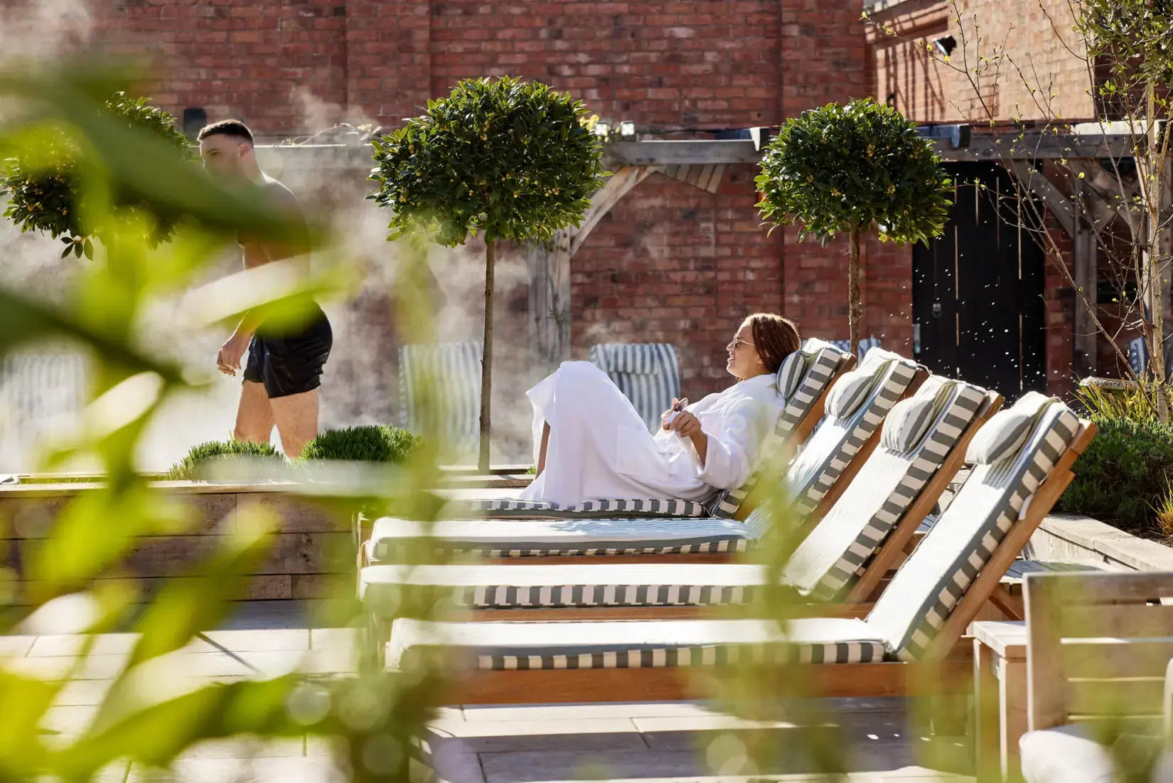 Pool side image of lady on lounger at Hiddenwell